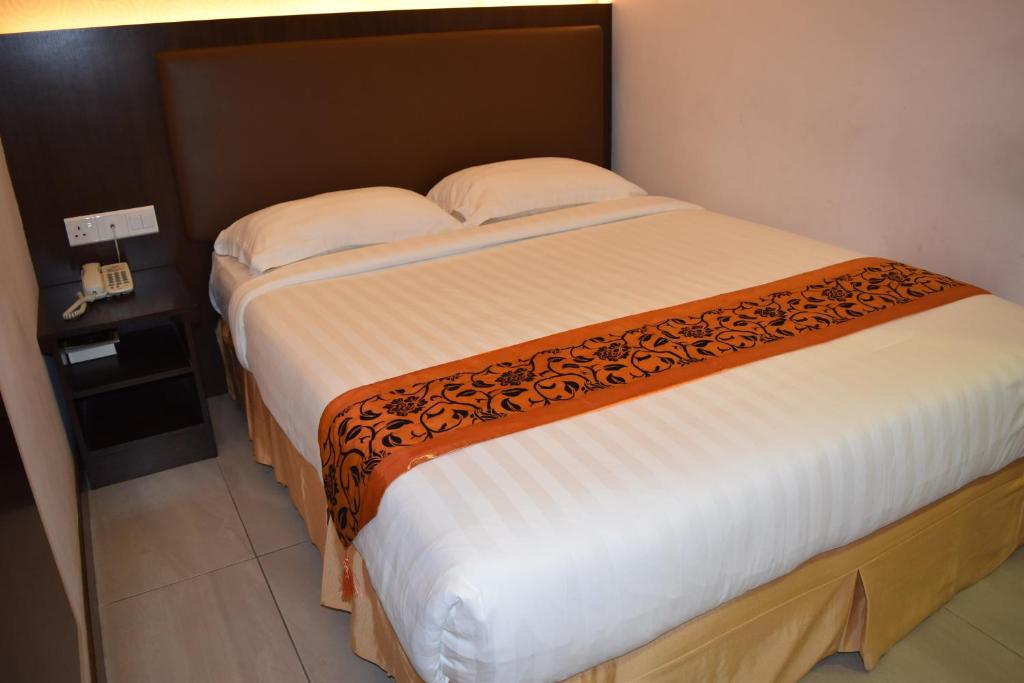 Postel nebo postele na pokoji v ubytování Sunrise Hotel
