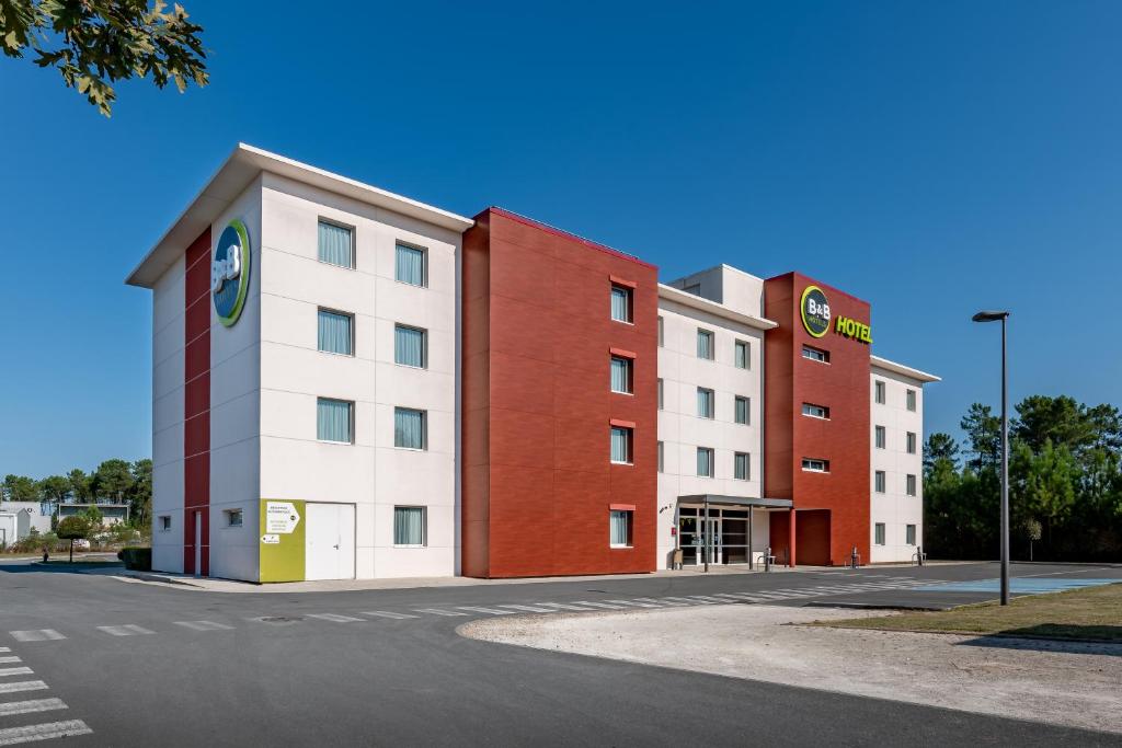 a row of buildings on the side of a street at B&B HOTEL Bordeaux Sud Mios in Mios