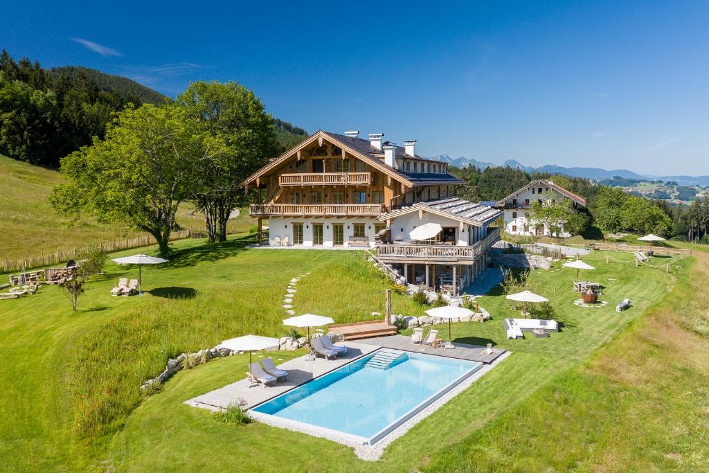 an aerial view of a large house with a swimming pool at Chiemsee Chalet in Frasdorf