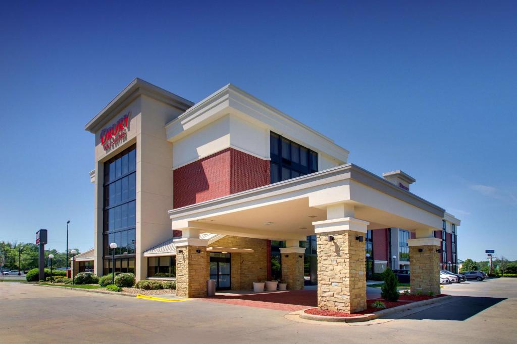 a hotel building with a sign on top of it at Drury Inn & Suites Greensboro in Greensboro