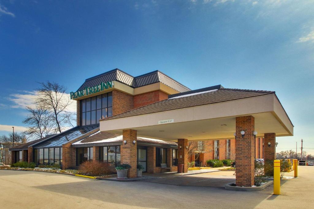 un bâtiment en briques avec un panneau en haut dans l'établissement Pear Tree Inn St. Louis Airport, à Edmundson