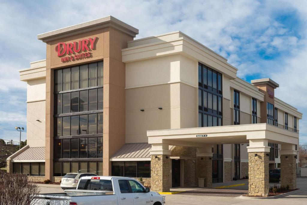 a dunkin donuts building with a car parked in front at Drury Inn & Suites Springfield MO in Springfield