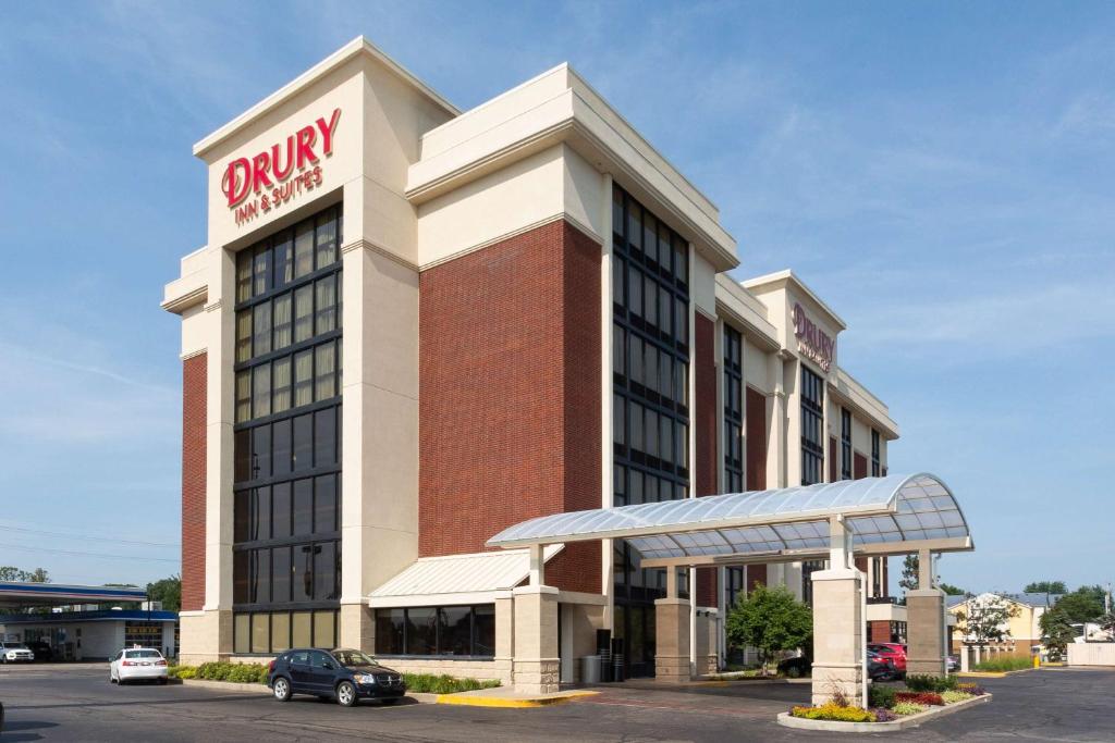 a building with a pharmacy sign on top of it at Drury Inn & Suites Terre Haute in Terre Haute