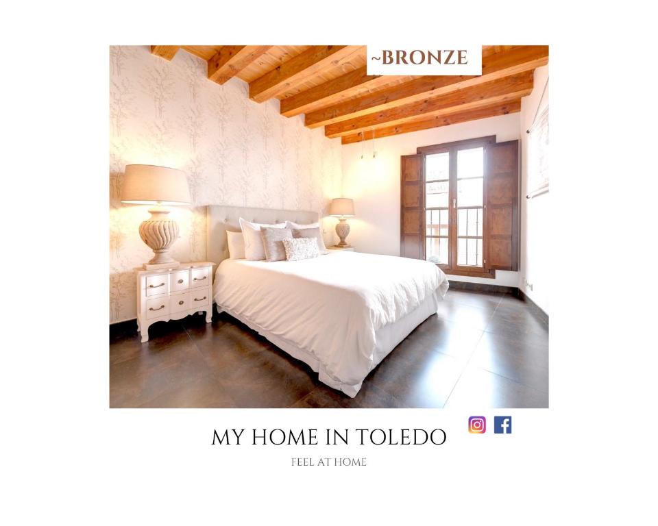 a bedroom with a white bed and a window at ~BRONZE~ Edificio Histórico S. XVI. Centro in Toledo