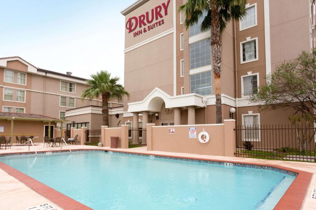 a swimming pool in front of a hotel at Drury Inn & Suites McAllen in McAllen