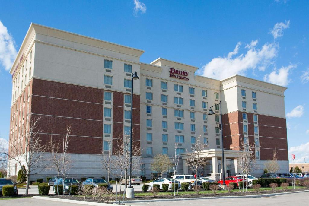 Drury Inn & Suites Columbus Grove City في غروف سيتي: مبنى الفندق مع وجود سيارات تقف في موقف للسيارات