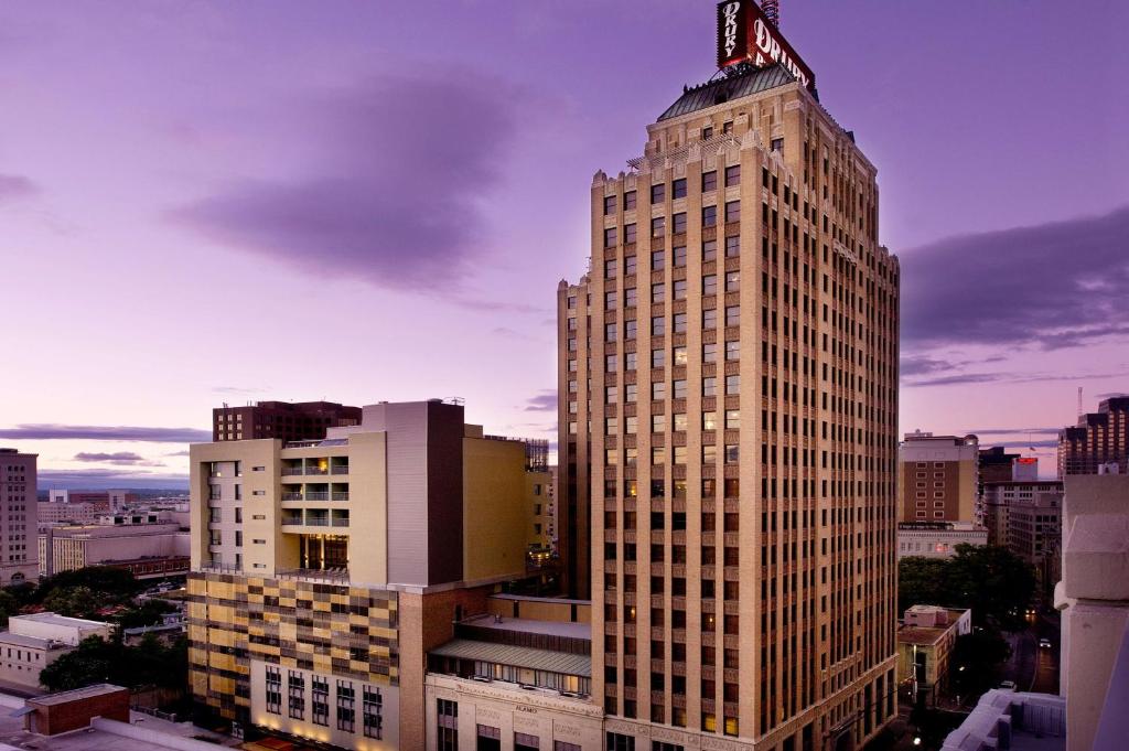 a tall building with a clock on top of it at Drury Plaza Hotel San Antonio Riverwalk in San Antonio