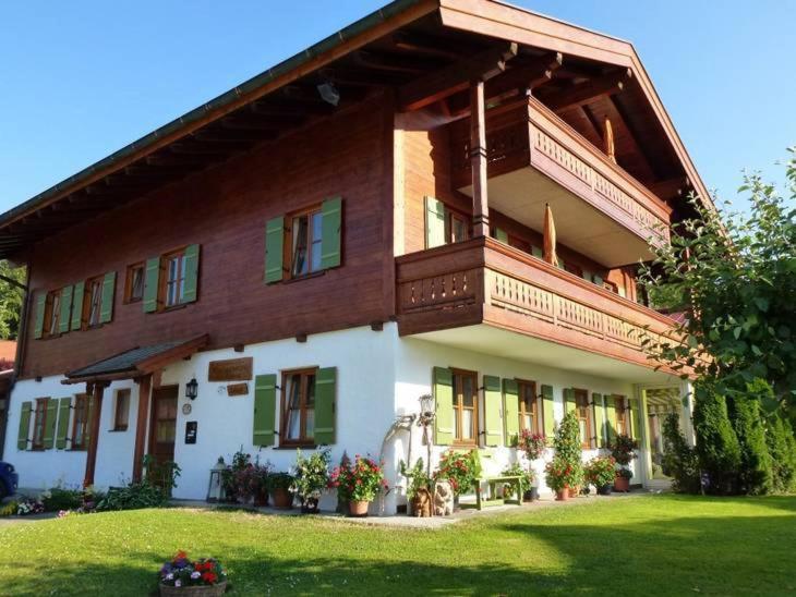 a large house with a balcony on top of it at Komfort Ferienwohnungen Reit im Winkl - Haus Davis in Reit im Winkl