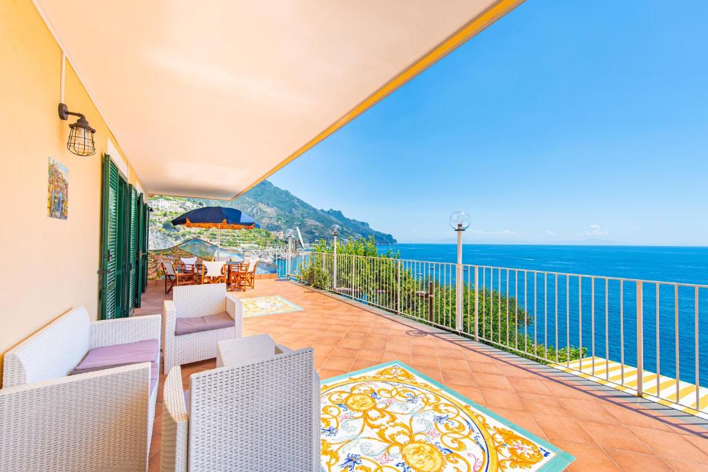 a balcony with chairs and a view of the ocean at Ravello Art Apartments in Ravello