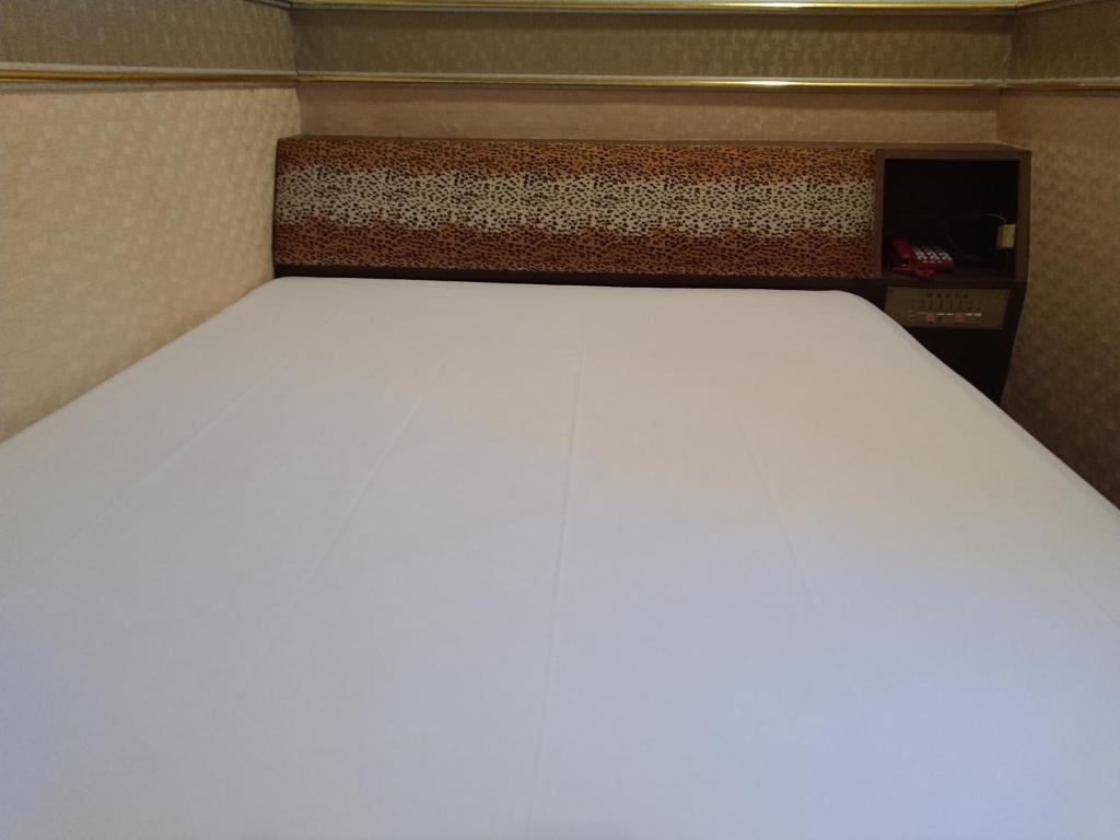 Postel nebo postele na pokoji v ubytování The LEY HOTEL 寶麗頌旅館