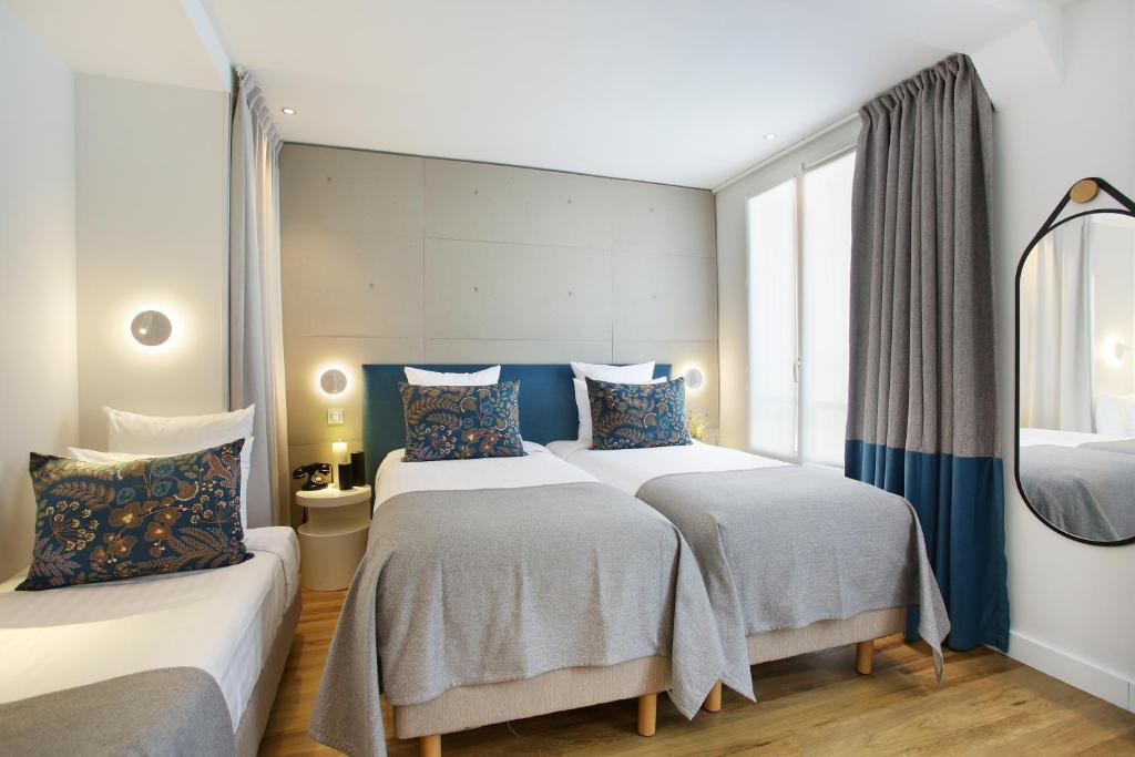 Postel nebo postele na pokoji v ubytování Le Basile Hôtel