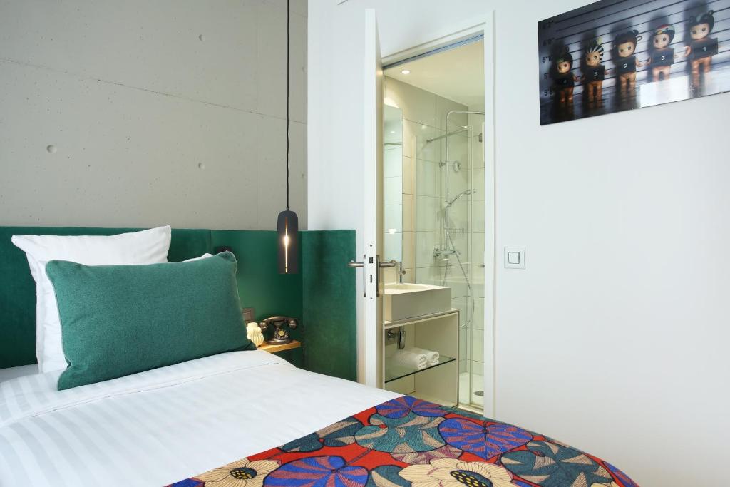 Postel nebo postele na pokoji v ubytování Le Basile Hôtel