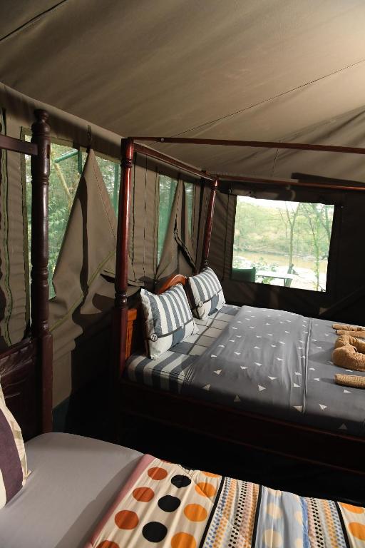 Postel nebo postele na pokoji v ubytování Mara Duma Bush Camp