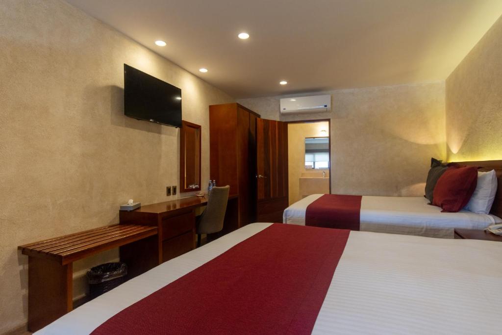 Postel nebo postele na pokoji v ubytování Hotel Madero