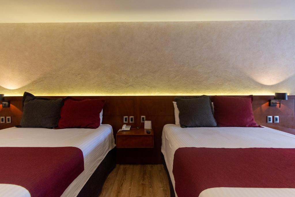 Postel nebo postele na pokoji v ubytování Hotel Madero