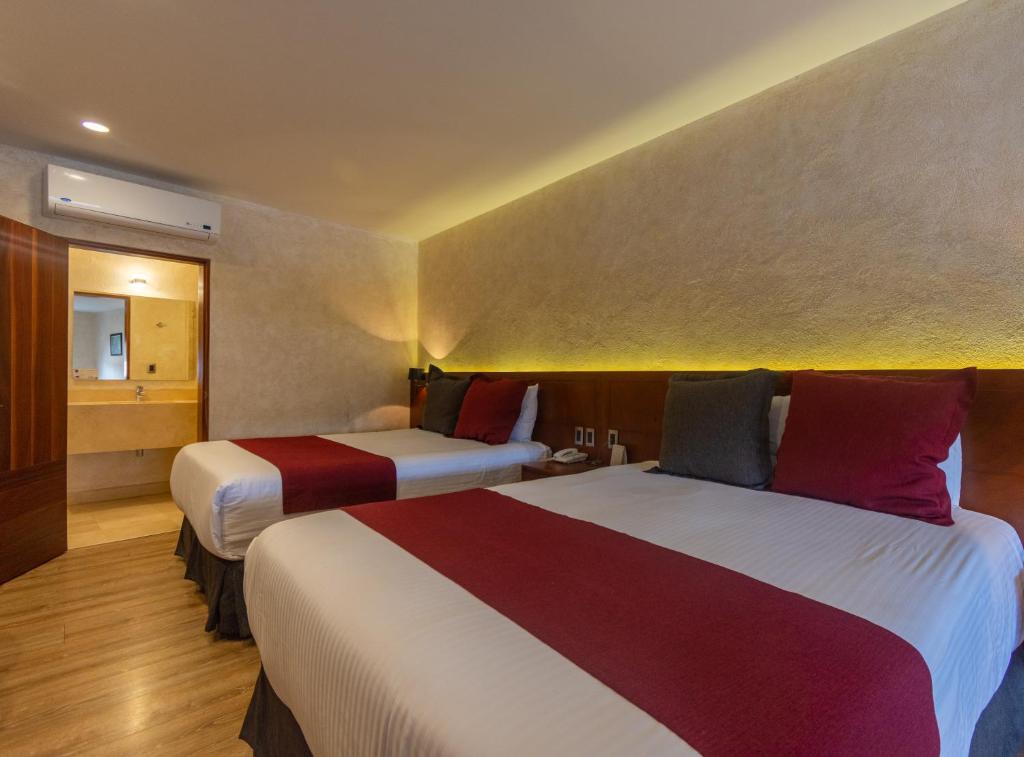 Postel nebo postele na pokoji v ubytování Hotel Madero