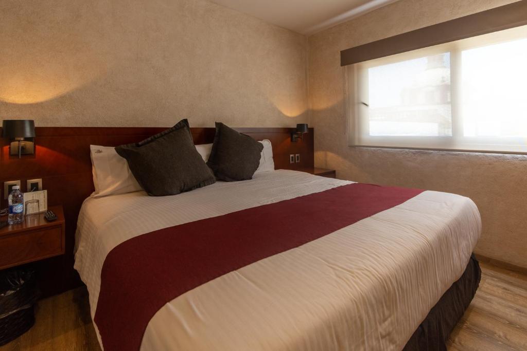 Postel nebo postele na pokoji v ubytování Hotel Madero