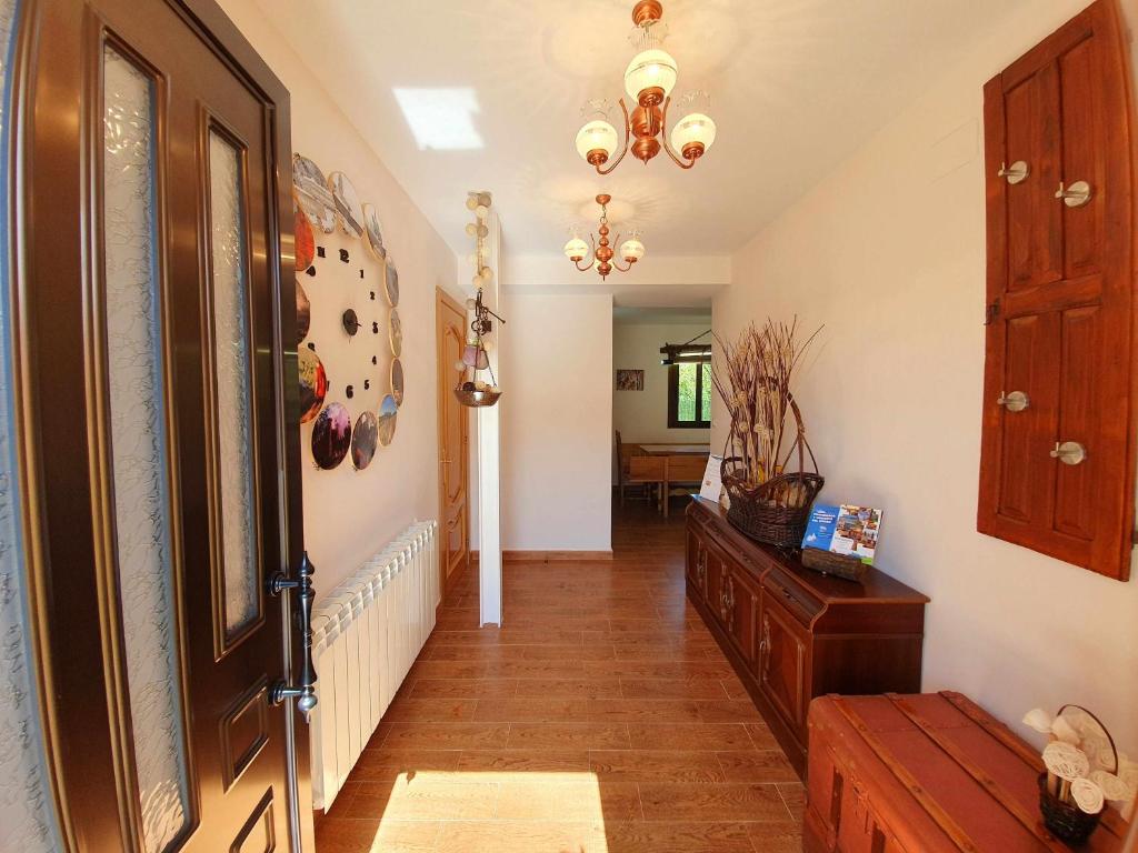 a hallway with a door and a room with a table at Casa Carreira Bierzo in Ponferrada