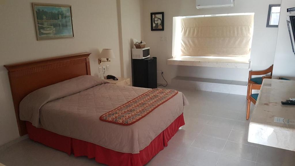 Postel nebo postele na pokoji v ubytování Hotel y Suites Nader