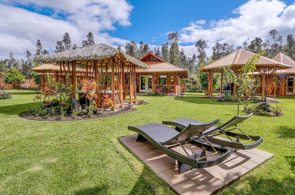 a yard with two lawn chairs and a pavilion at Volcano Eco Retreat by Heart Core Hotels - Adults Only in Mountain View
