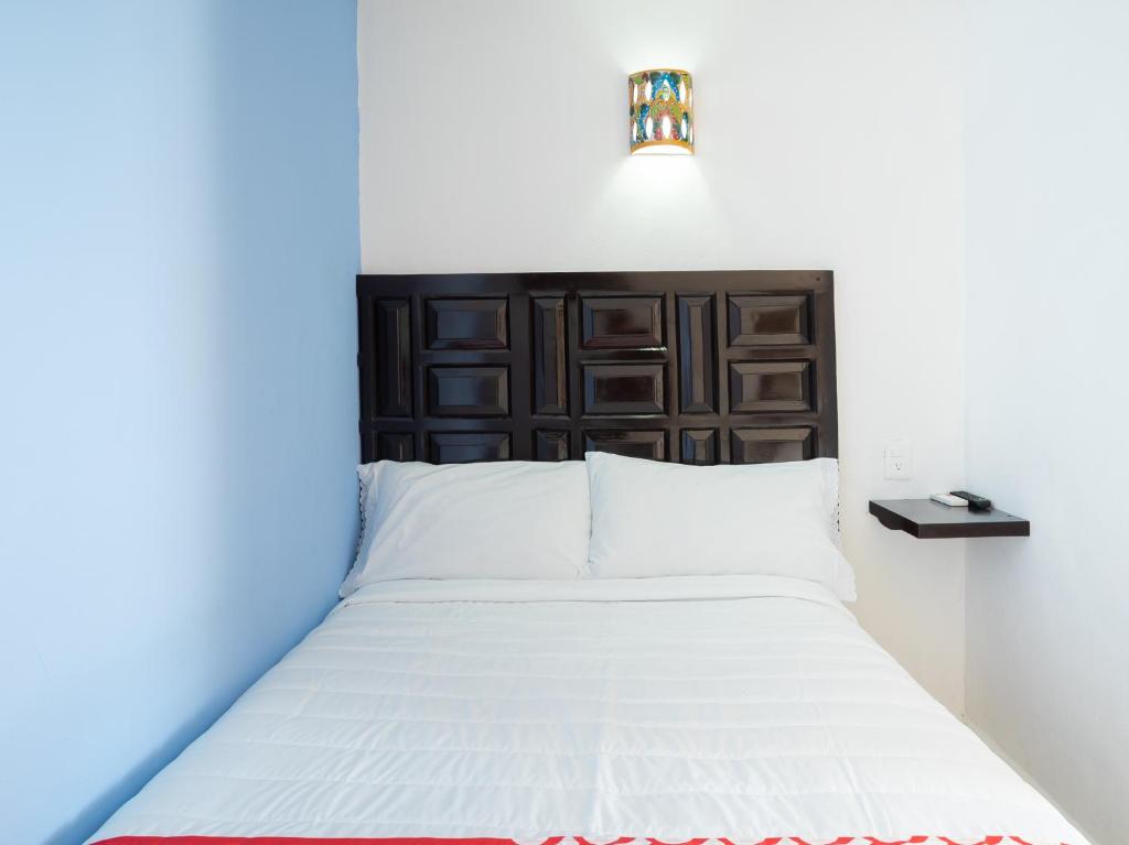 Postel nebo postele na pokoji v ubytování Hotel Casa Poblana