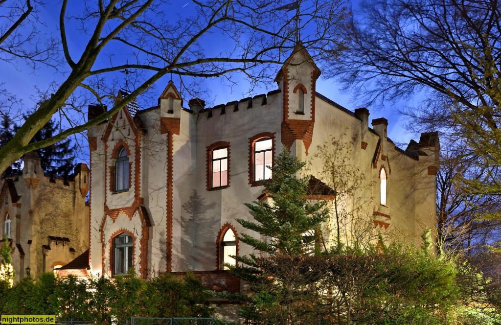 an old castle is lit up at night at Lilienthalschlösschen in Berlin