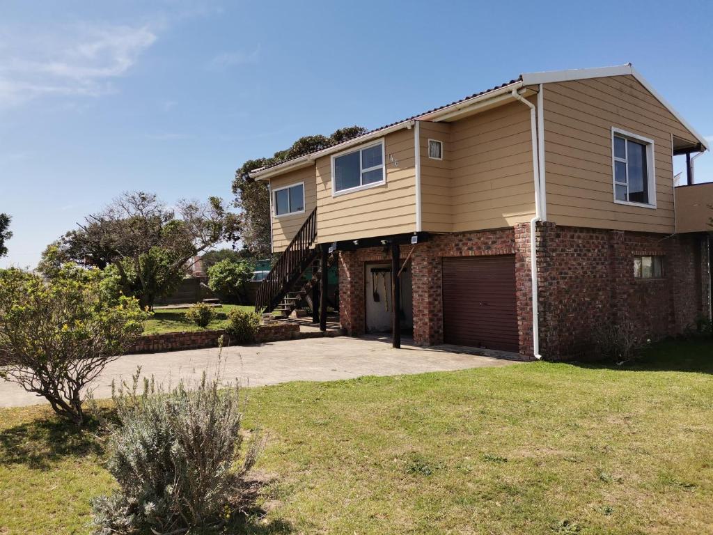 a house with a garage in a yard at Kayser's Sea Breeze in East London