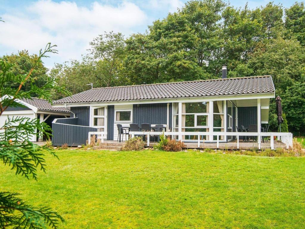 a house with a lawn in front of it at 6 person holiday home in Silkeborg in Silkeborg