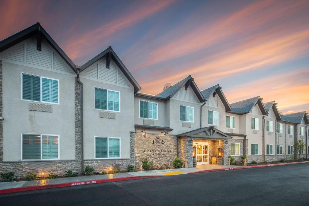 a row of homes with a sunset in the background at Aristocrat Hotel, BW Signature Collection in Half Moon Bay