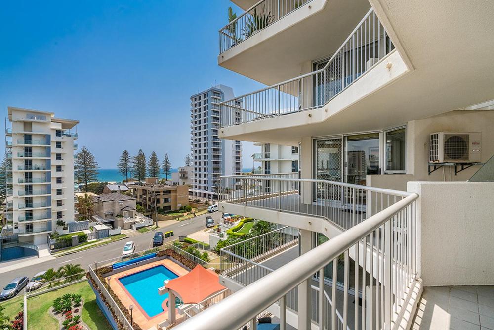 an aerial view of a building with a swimming pool at Rainbow Bay Resort Holiday Apartments in Gold Coast