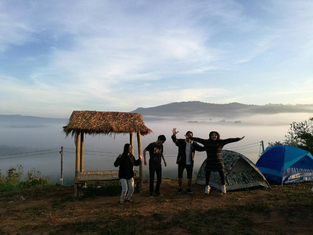 a group of people standing next to a tent at ไร่ภูจำปา in Khao Kho
