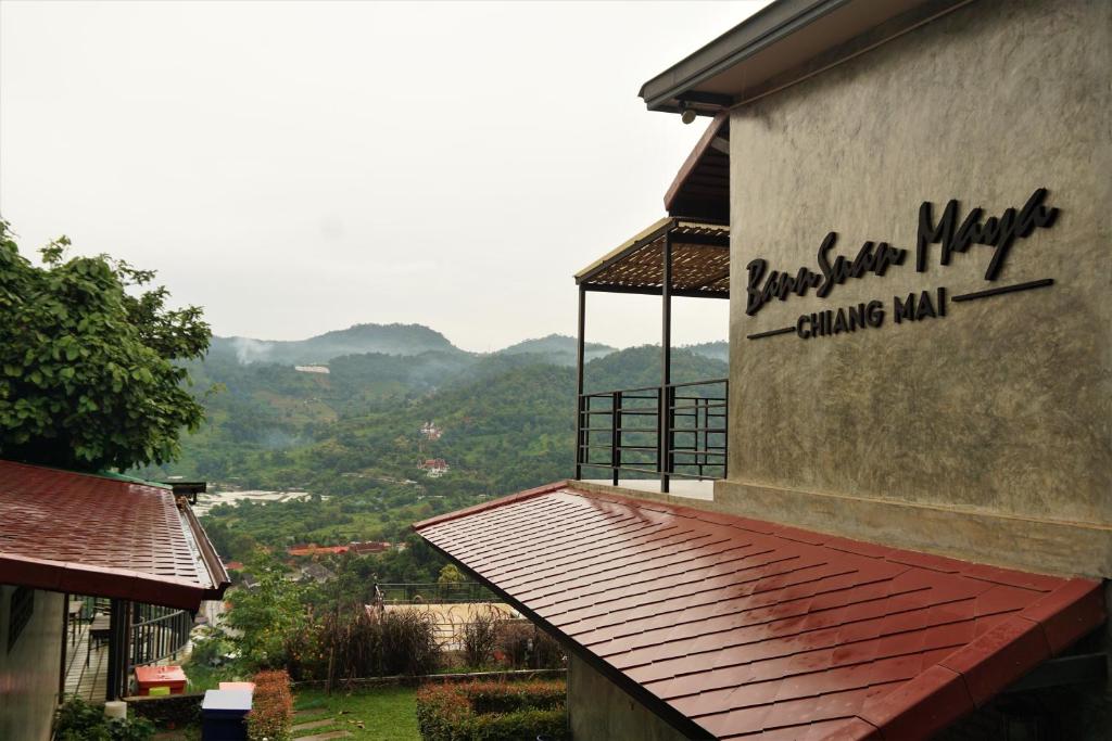 a building with a sign on the side of it at Bann Suan Maya in Mae Rim