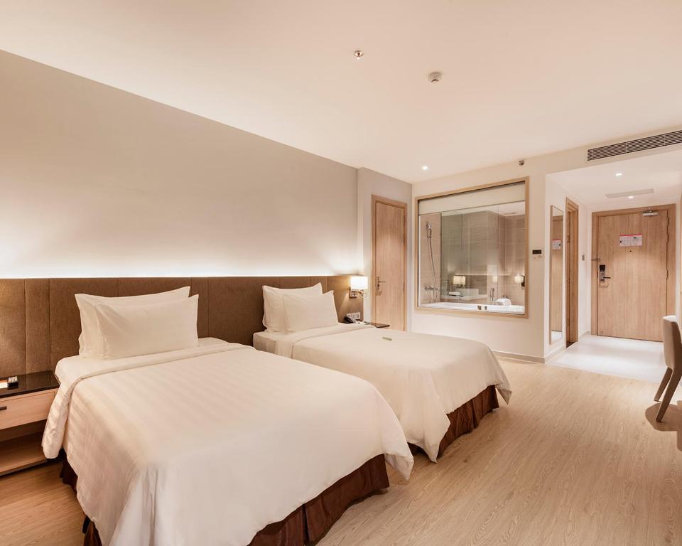 Postel nebo postele na pokoji v ubytování DQua Hotel