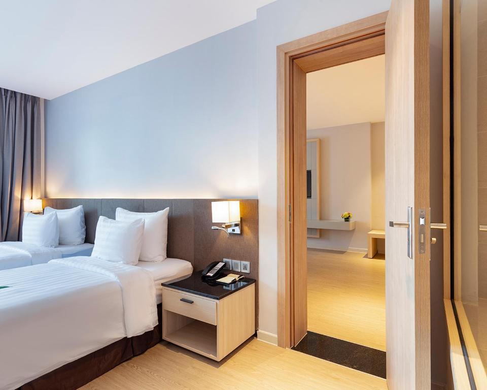 Postel nebo postele na pokoji v ubytování DQua Hotel