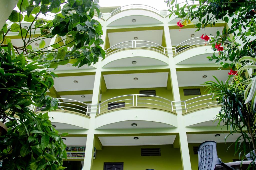 a building with balconies and trees in front of it at Lumbini Guest House in Lumbini