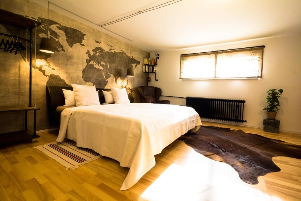 a bedroom with a large bed with a map on the wall at Little Beauty Souterrain Apartment Linkenheim in Linkenheim-Hochstetten