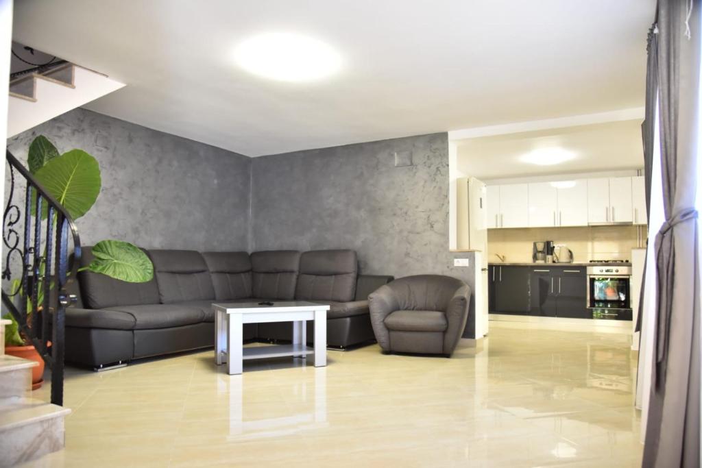 a living room with a couch and a table at Casa Sophia Maria Caciulata in Caciulata