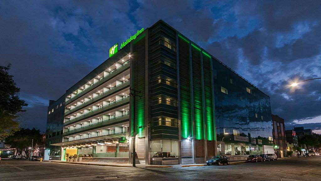 Un edificio con luces verdes a los lados. en Holiday Inn Mexico Zona Centro by IHG, en Ciudad de México