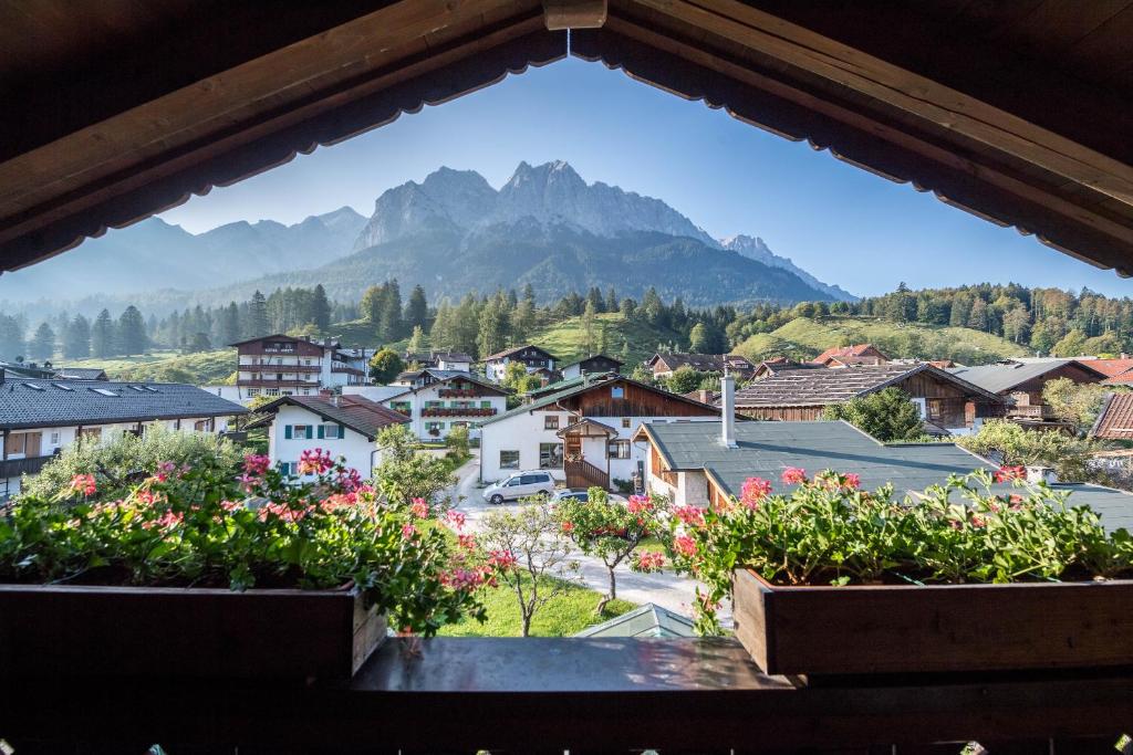 a view from a window of a town with mountains at Ferienwohnung Gipfelblick in Grainau