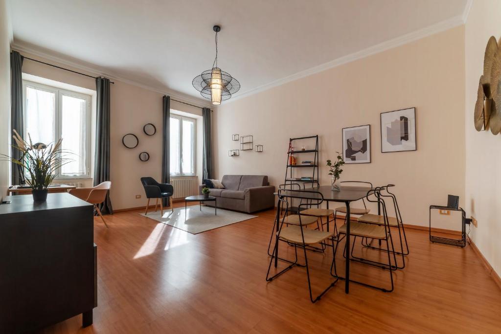 a living room with a table and a couch at Rione Prati Apartment - MM Lepanto in Rome