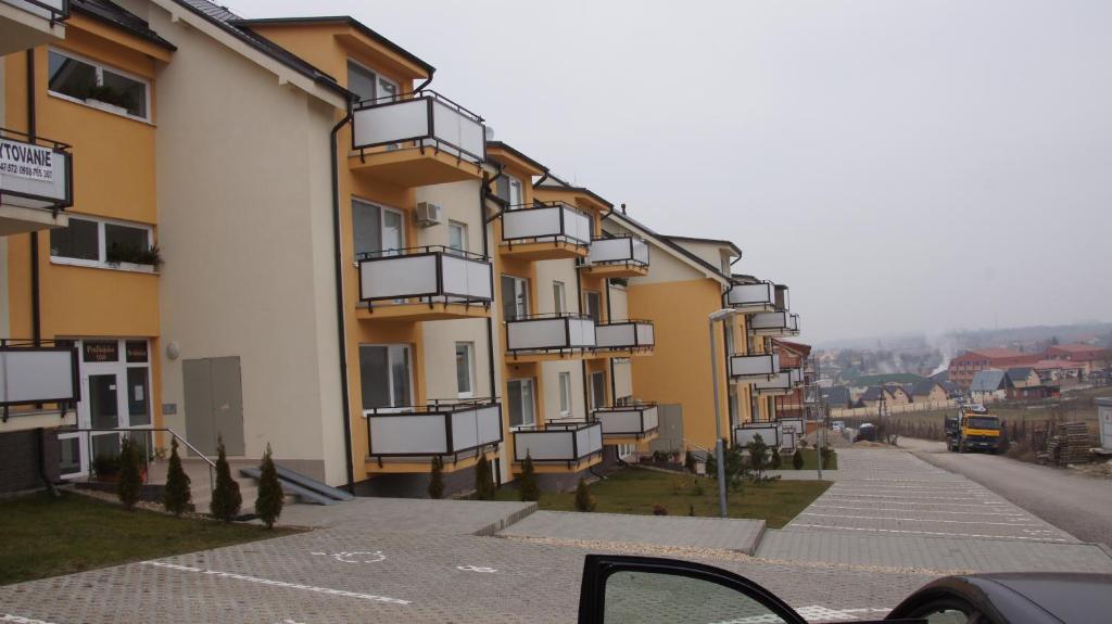 a building with balconies on the side of a street at Apartmany Podhajska in Podhájska