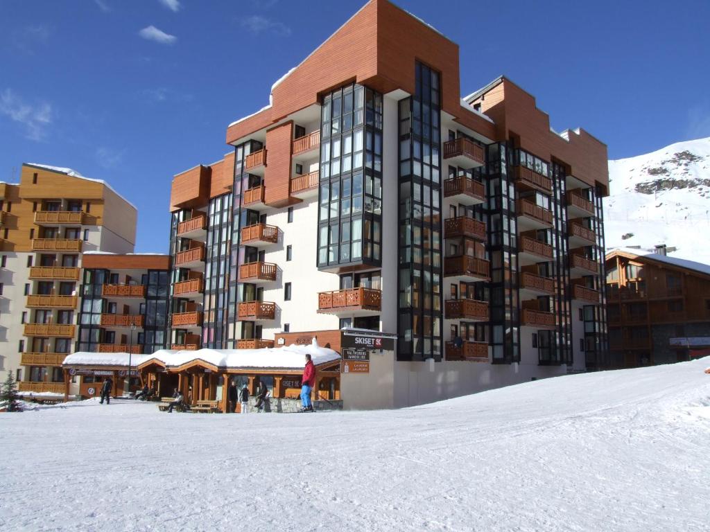 a large building in the snow in front at Eskival Appartements VTI in Val Thorens