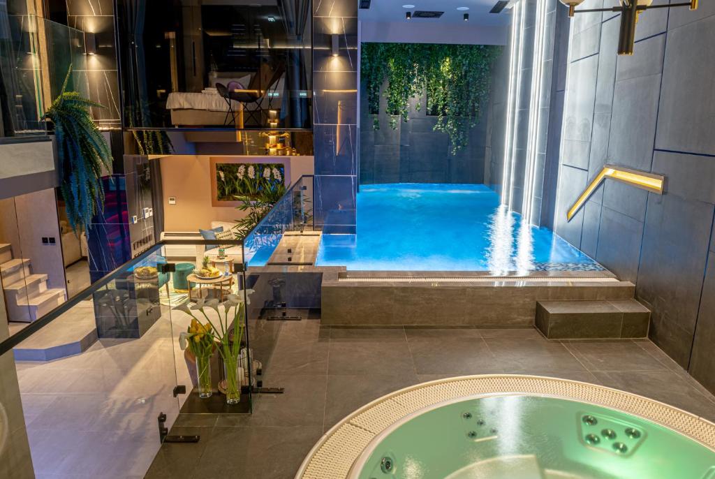 a bathroom with a jacuzzi tub in a building at Marconio Wellness Private Pool & SPA - City Center in Belgrade