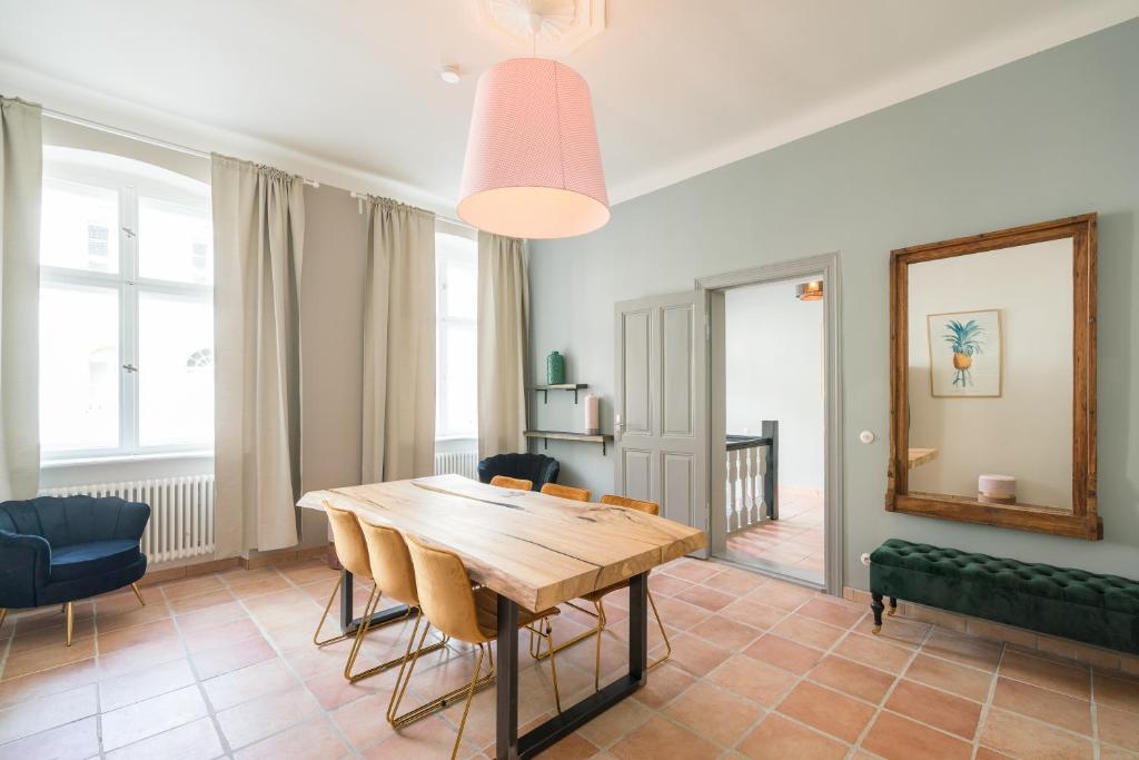 a dining room with a wooden table and chairs at Design Apartments -Innenstadt in Potsdam