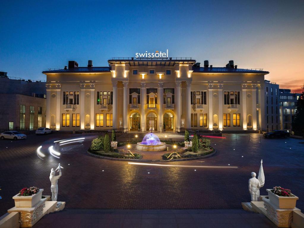 a large building with a fountain in front of it at Swissôtel Resort Sochi Kamelia in Sochi