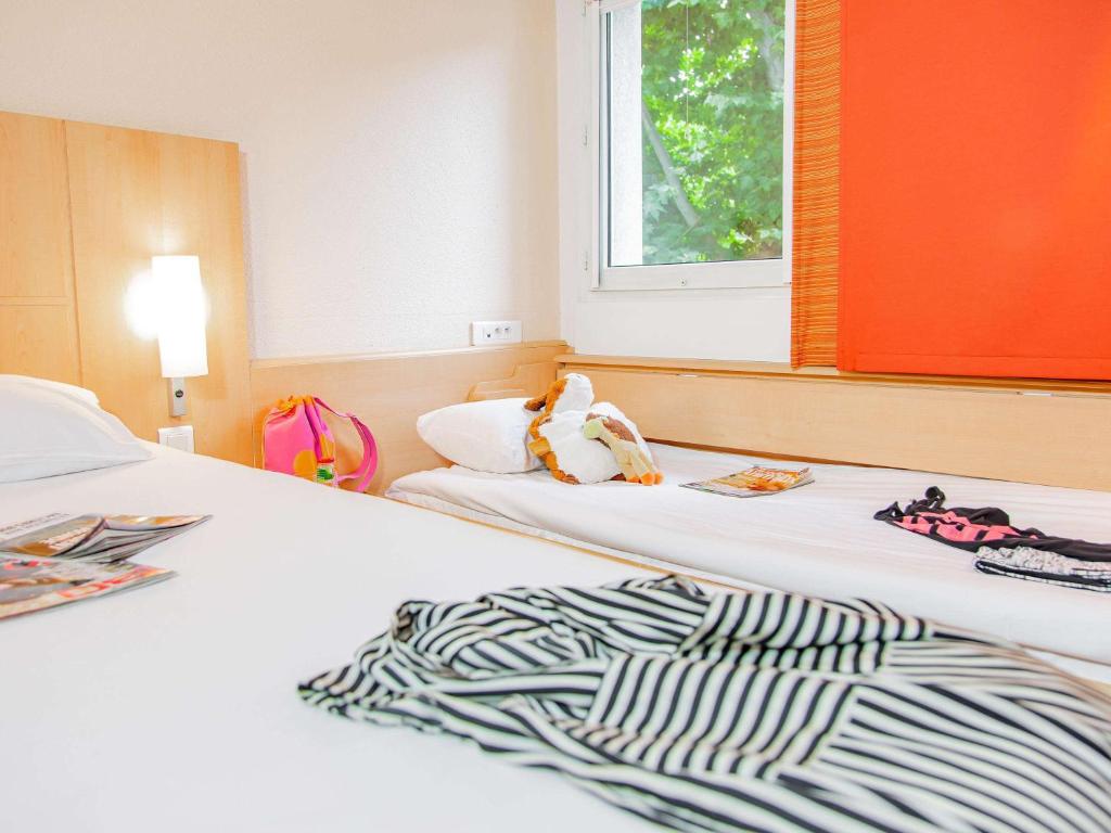 Postel nebo postele na pokoji v ubytování ibis Mulhouse Ile Napoleon
