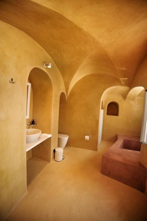 W pokoju znajduje się łazienka z umywalką i toaletą. w obiekcie Amaya Bliss Villa Caldera View-Outdoor Hot Tub Oia Santorini w mieście Thólos