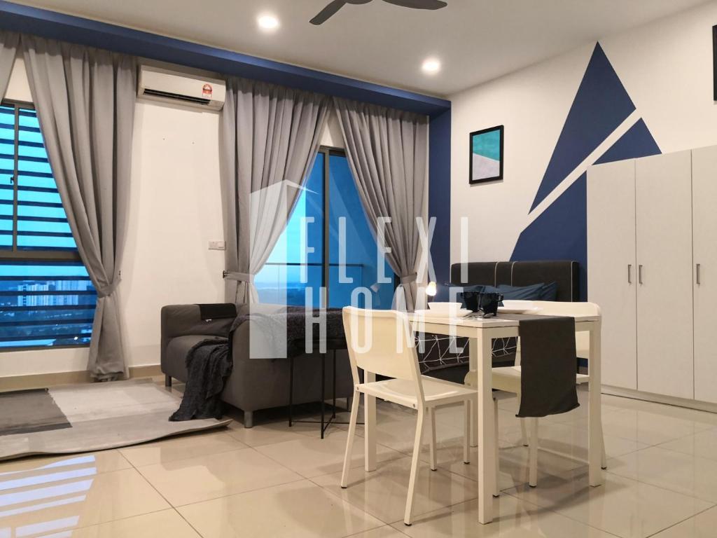 a dining room with a white table and chairs at 1-2 Guests, Cybersquare Private Studio - Cyberjaya, Flexihome-MY in Cyberjaya