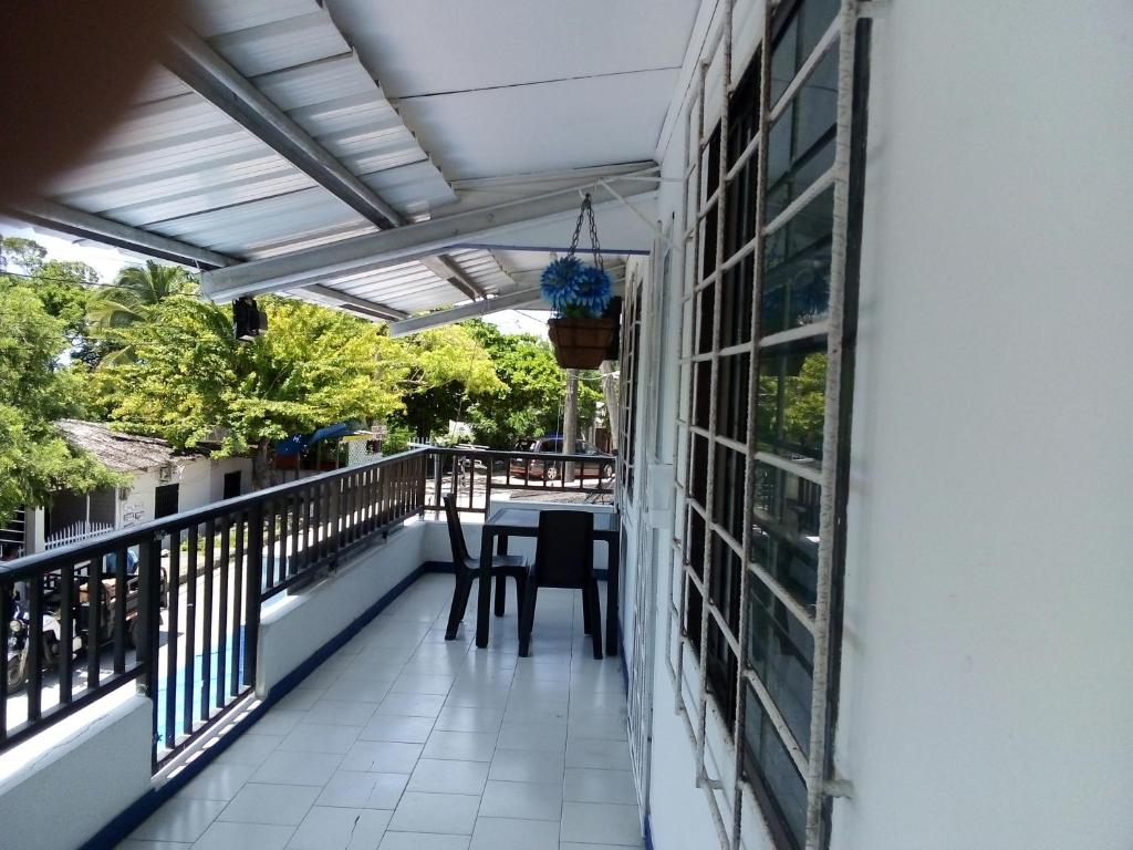 a balcony with a table and chairs on it at Marysol Lodging in San Andrés