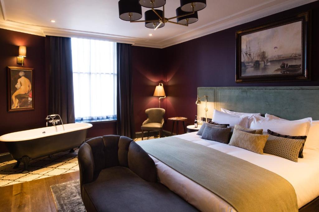 a bedroom with a large bed and a bath tub and a sink at Avon Gorge by Hotel du Vin in Bristol